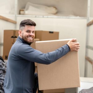 Ben holding a packed box ready for moving house